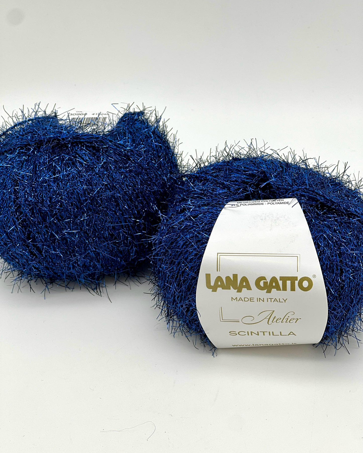 Two balls of blue yarn with a label on a white background