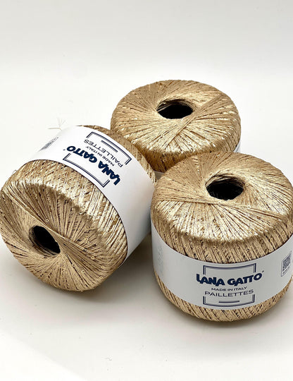 Lana Gatto Paillettes yarn in shimmering pastel tones, with delicate 2mm sequins, lightweight polyester yarn ideal for adding sparkle to knit or crochet projects. Made in Italy. 30784 light gold color.