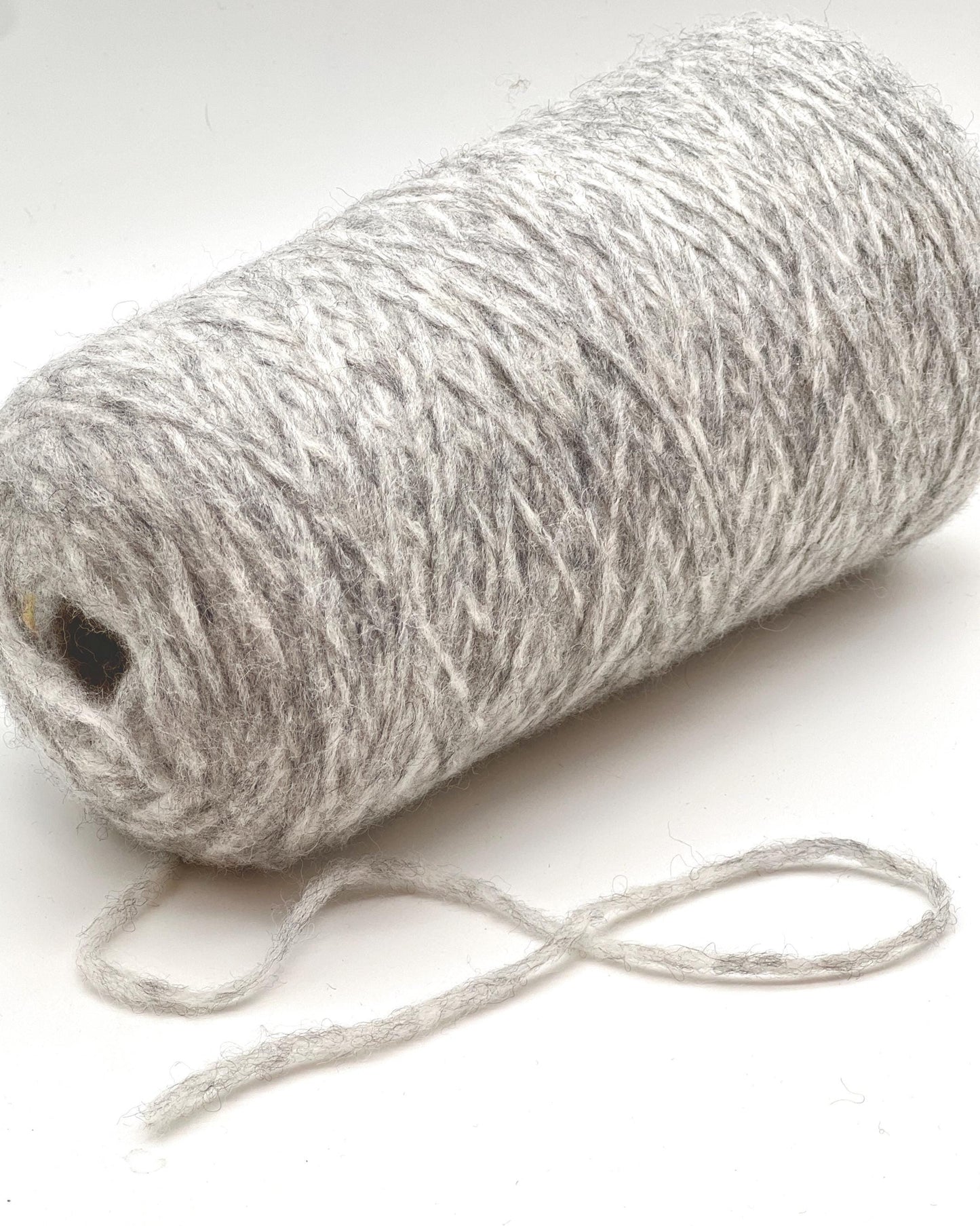 Ball of gray yarn on a white background