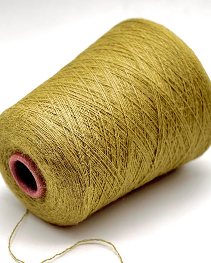 Spool of green yarn on a white background