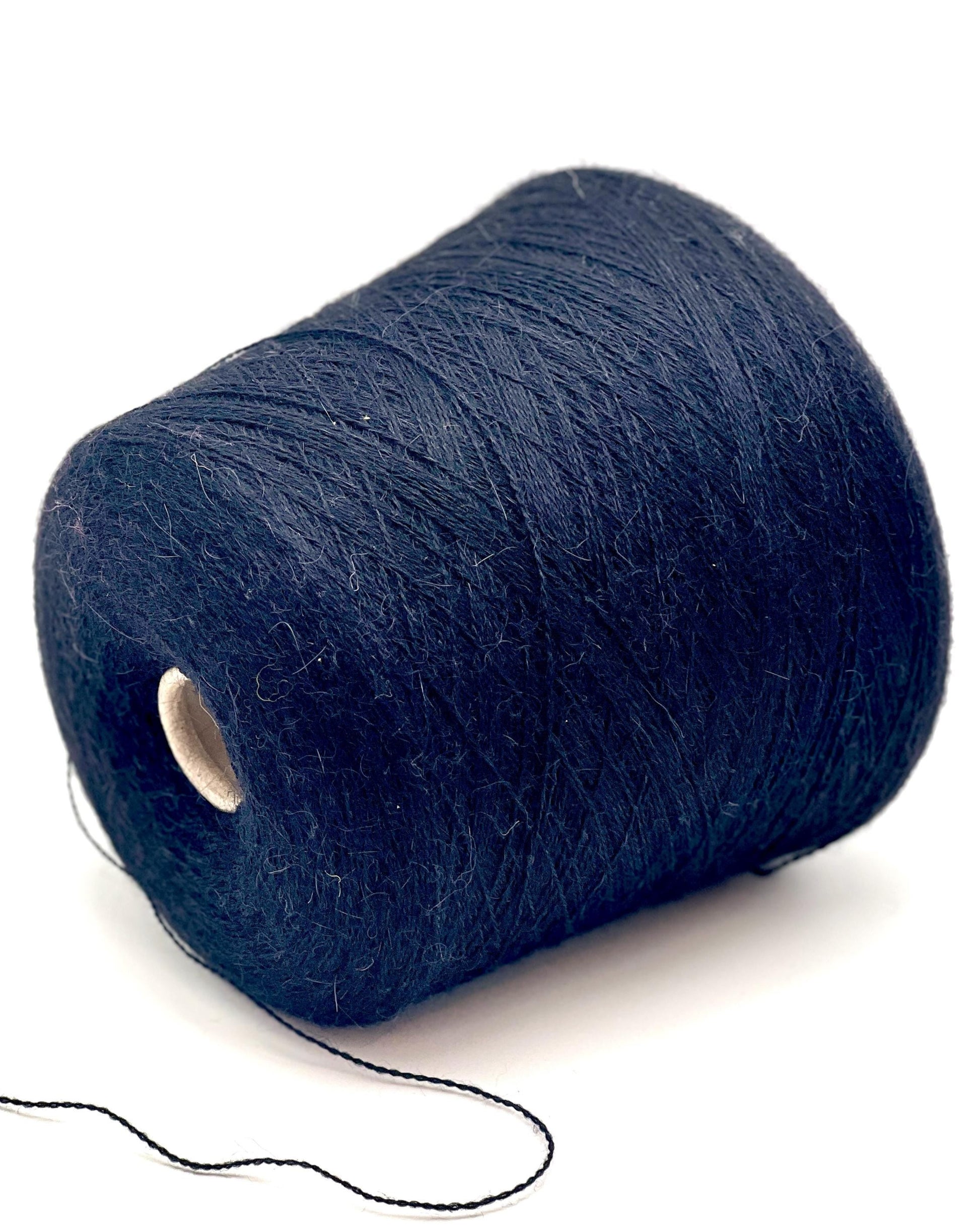 Spool of dark blue thread on a white background