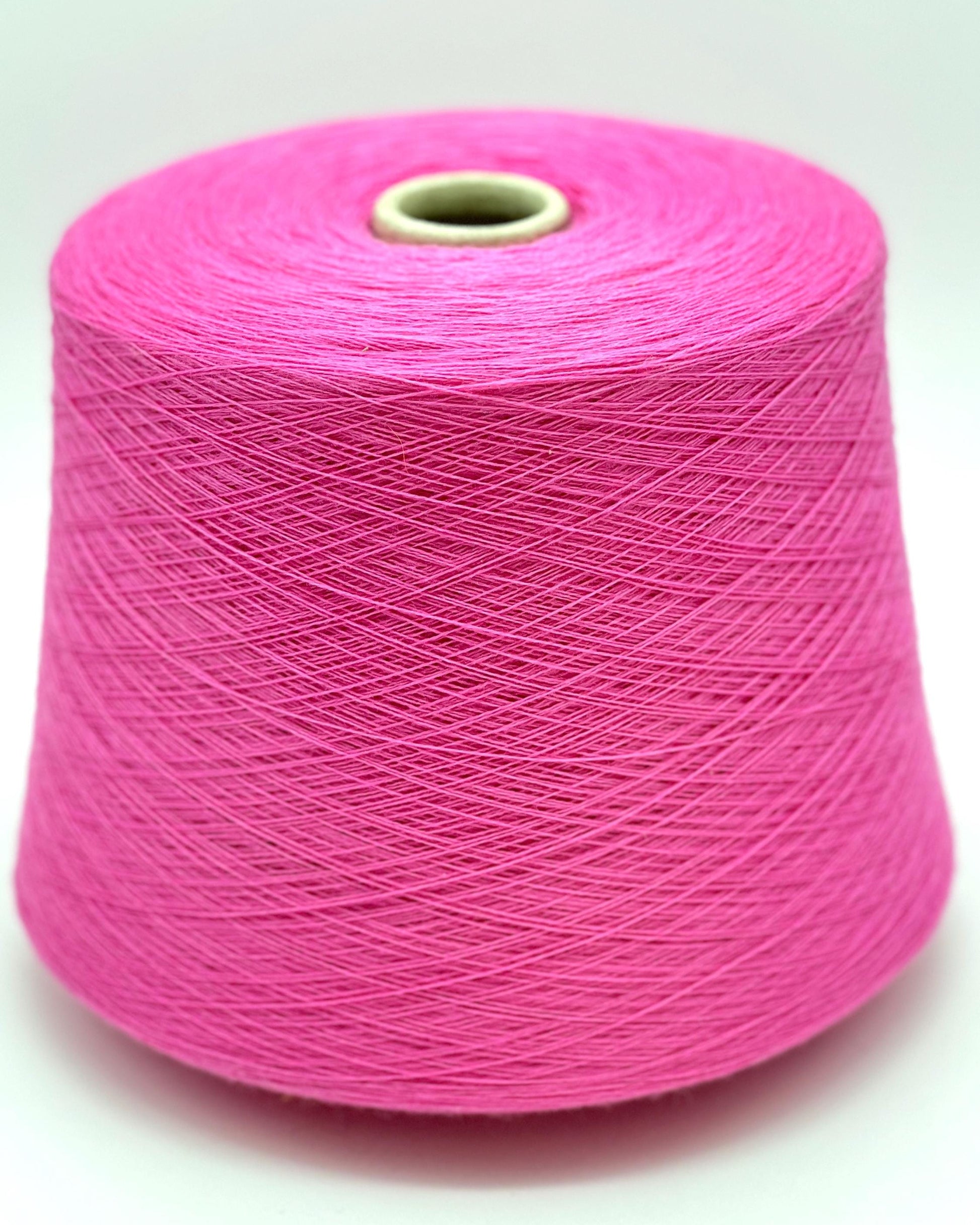Pink spool of yarn on a white background