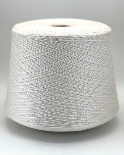 Spool of white yarn on a gray background