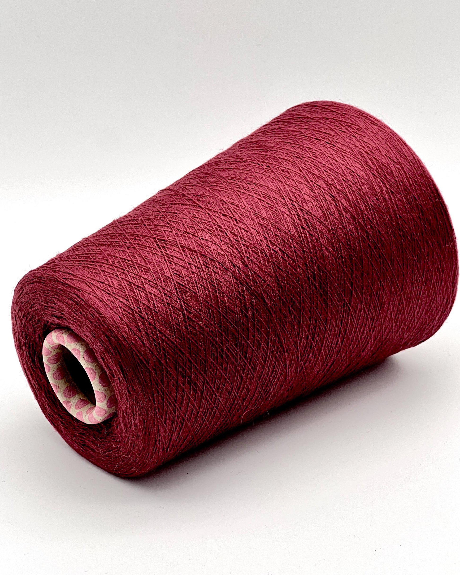 Red spool of yarn on a white background
