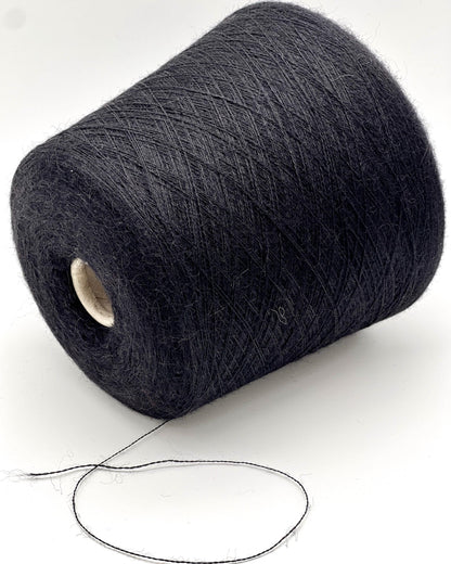Spool of dark gray yarn on a white background