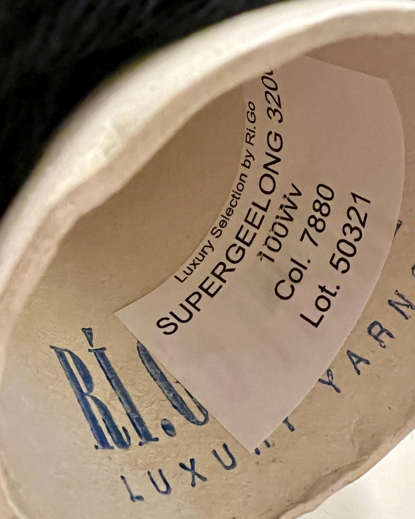 A curated collection of RiGo Supergeelong premium merino wool yarn in a palette of sophisticated neutrals and soft pinks. The image highlights the smooth, even texture and excellent stitch definition of this 100% Italian-made DK/Sport weight fiber. Authentic luxury yarn available at iDOKNiT.com.