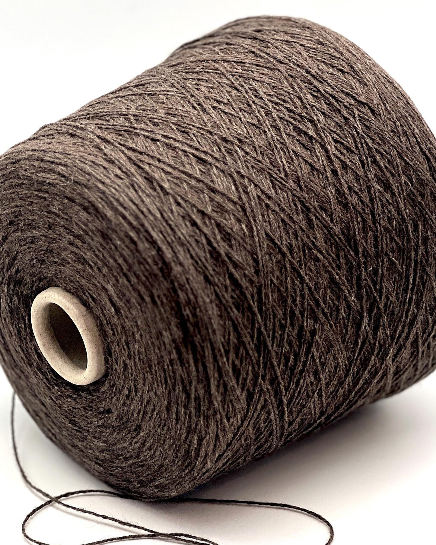 Brown yarn spool on a white background