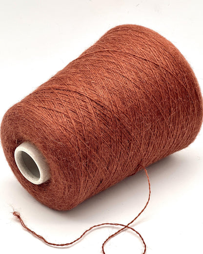Spool of brown yarn on a white background