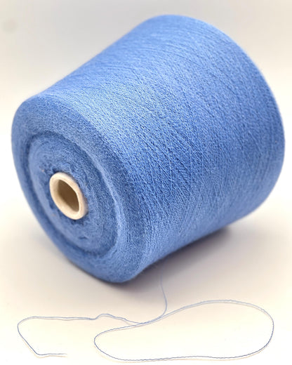 Blue spool of yarn on a white background