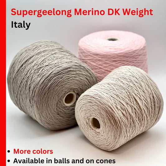 A curated collection of RiGo Supergeelong premium merino wool yarn in a palette of sophisticated neutrals and soft pinks. The image highlights the smooth, even texture and excellent stitch definition of this 100% Italian-made DK/Sport weight fiber. Authentic luxury yarn available at iDOKNiT.com.