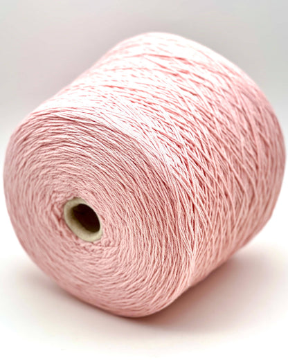 A curated collection of RiGo Supergeelong premium merino wool yarn in a palette of sophisticated neutrals and soft pinks. The image highlights the smooth, even texture and excellent stitch definition of this 100% Italian-made DK/Sport weight fiber. Authentic luxury yarn available at iDOKNiT.com.