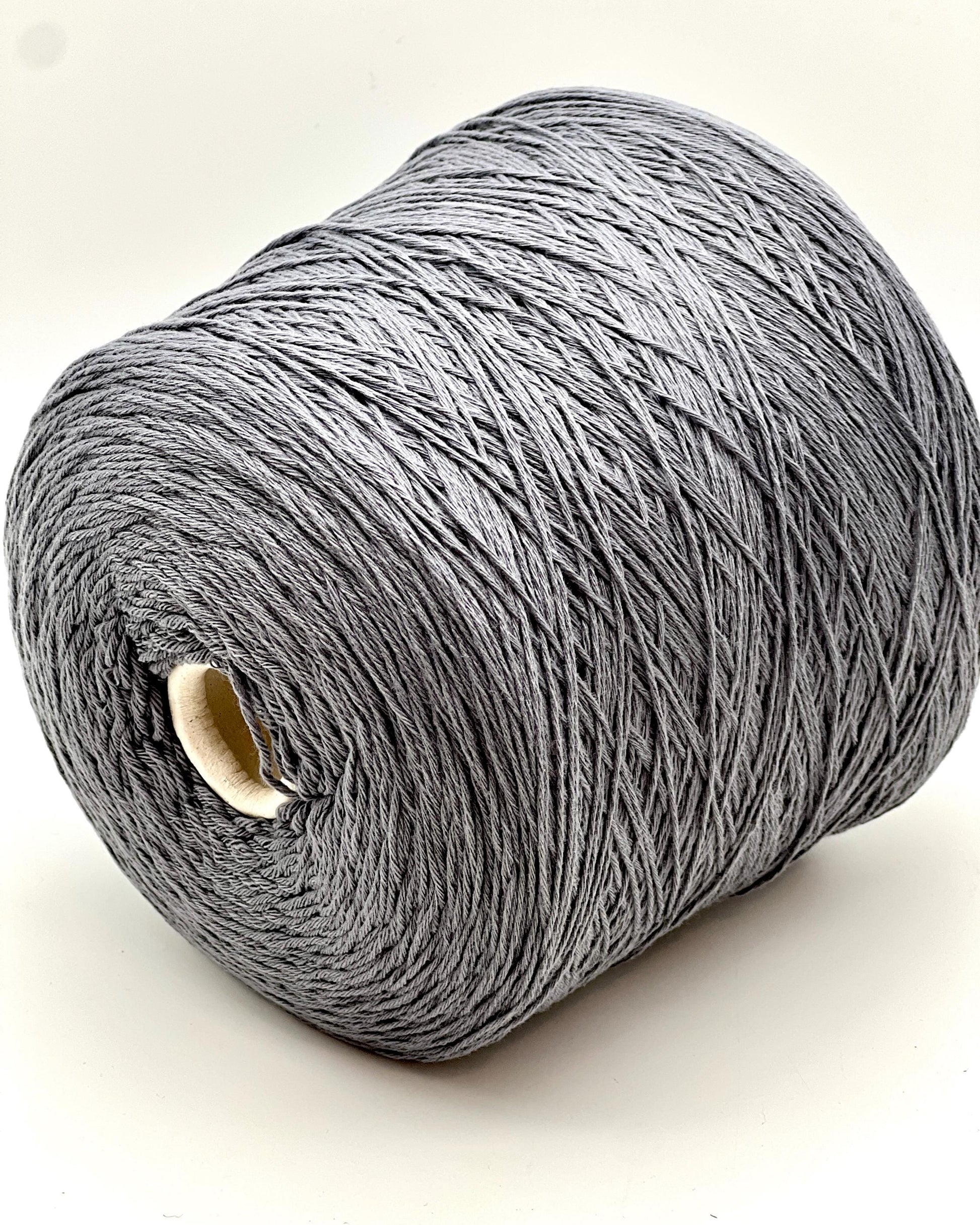 A curated collection of RiGo Supergeelong premium merino wool yarn in a palette of sophisticated neutrals and soft pinks. The image highlights the smooth, even texture and excellent stitch definition of this 100% Italian-made DK/Sport weight fiber. Authentic luxury yarn available at iDOKNiT.com.