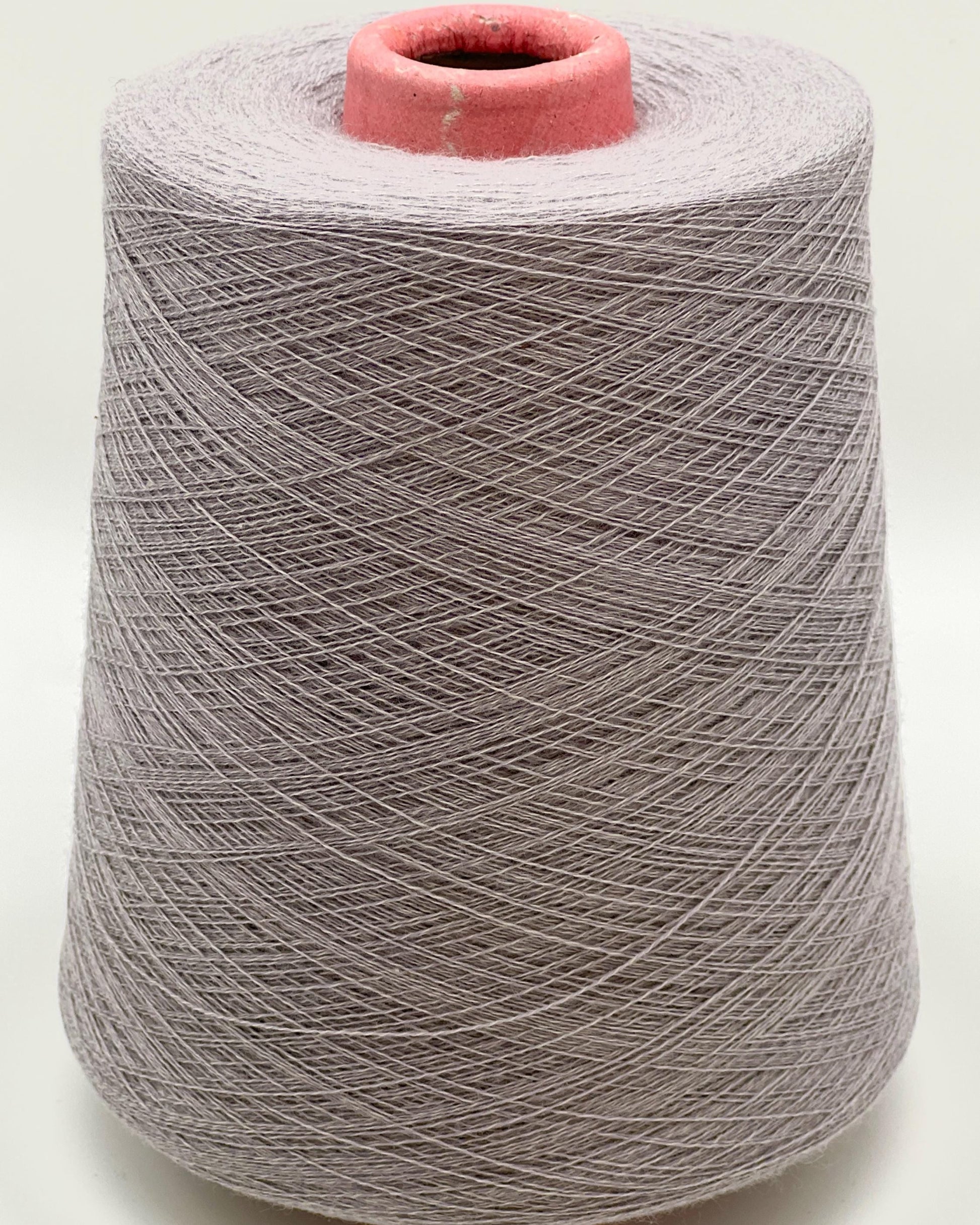Spool of gray yarn on a white background