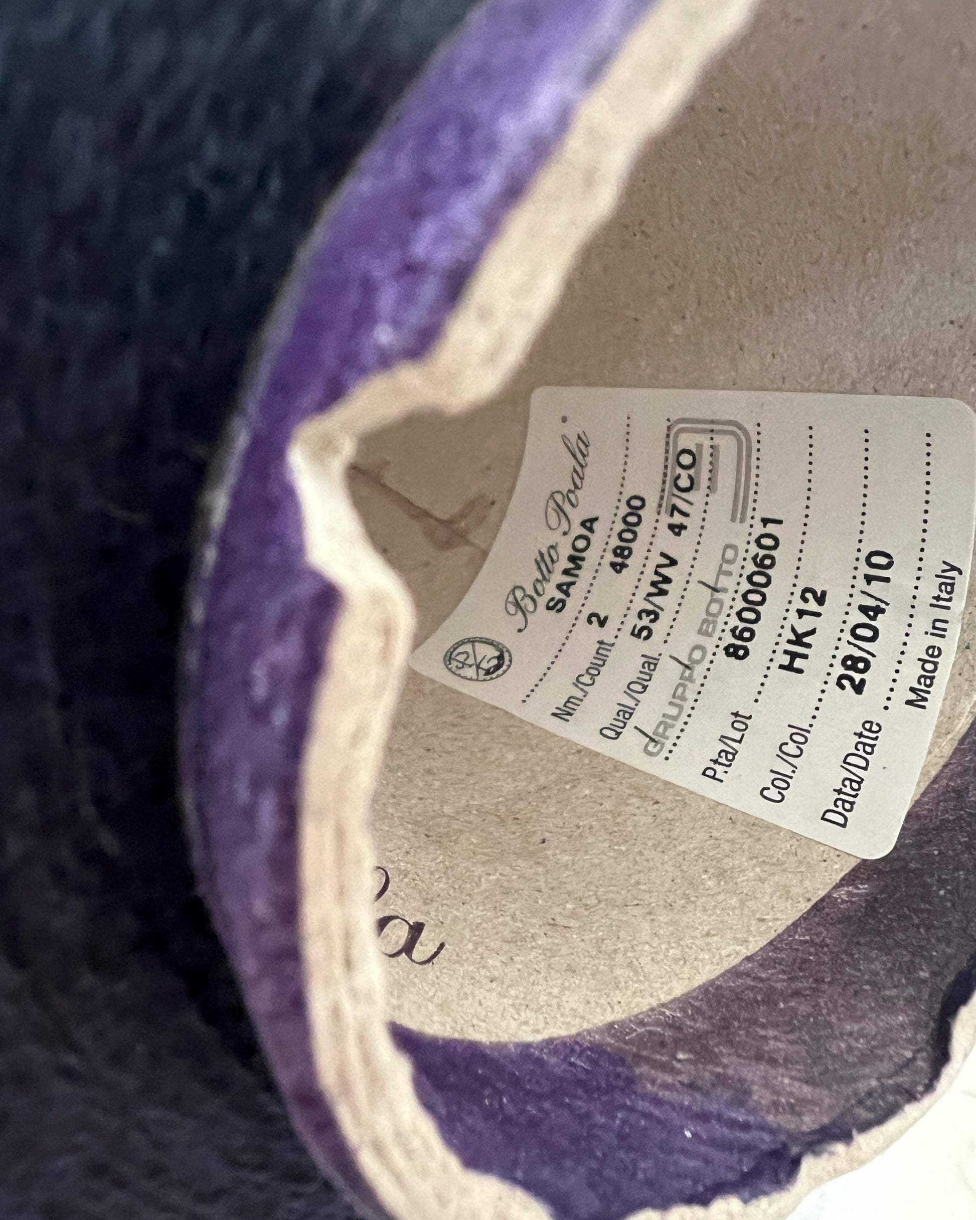 Close-up of a label inside a purple shoe with brand details.