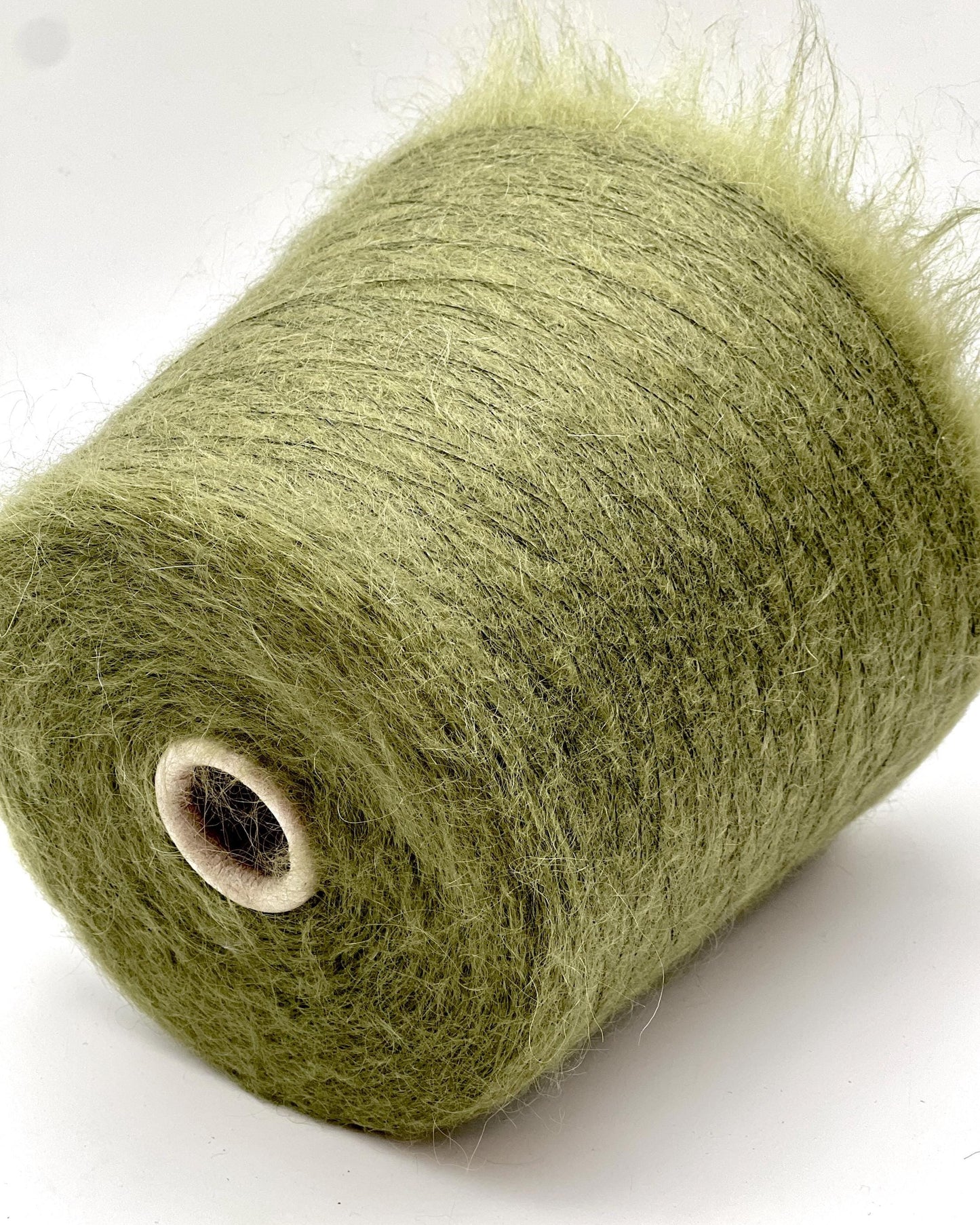 Green yarn roll on a white background