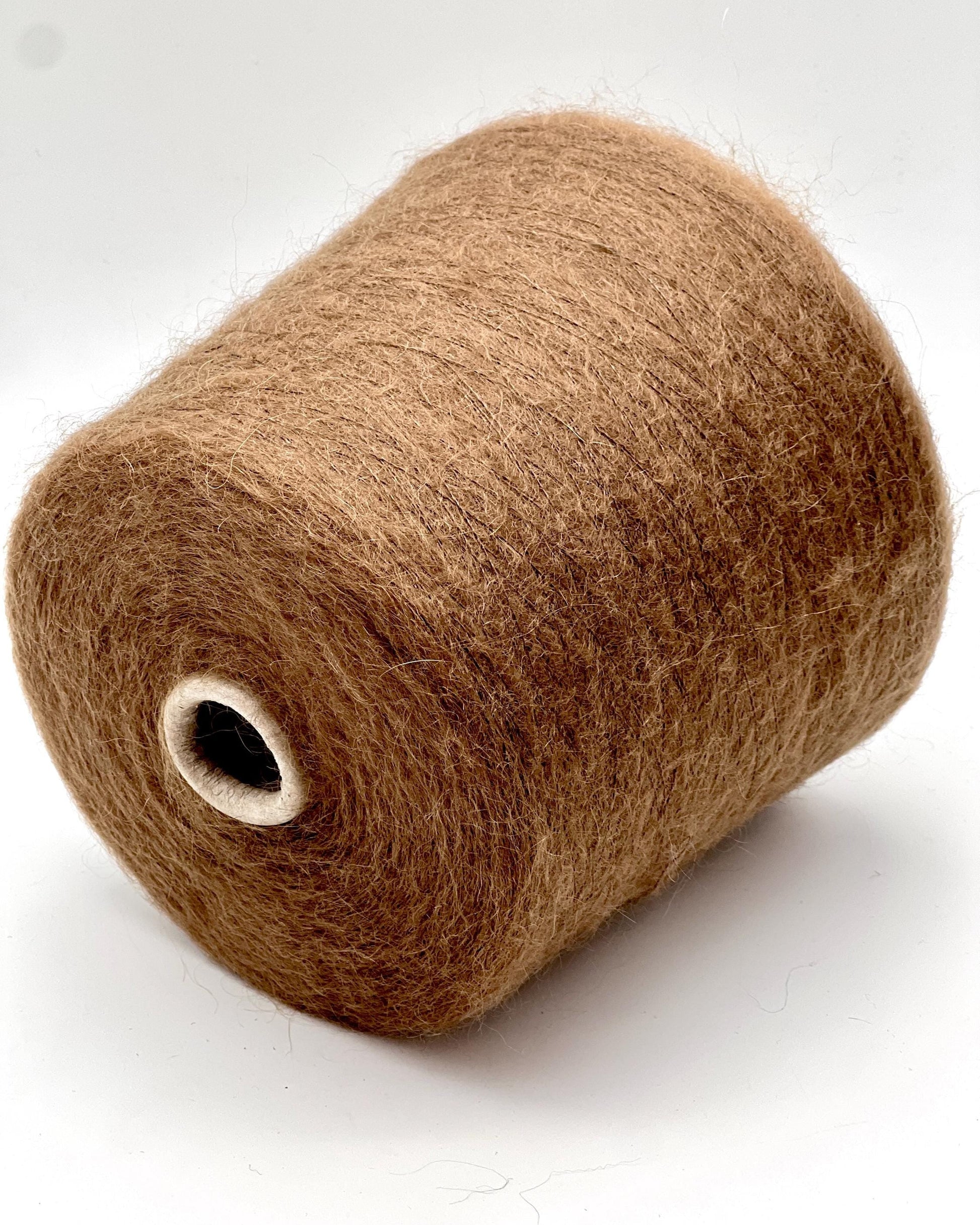 Brown spool of yarn on a white background