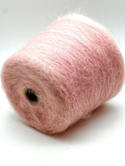 Pink yarn spool on a white background