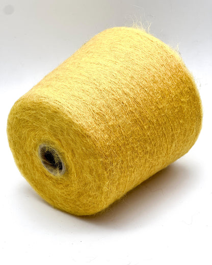 Yellow spool of yarn on a white background