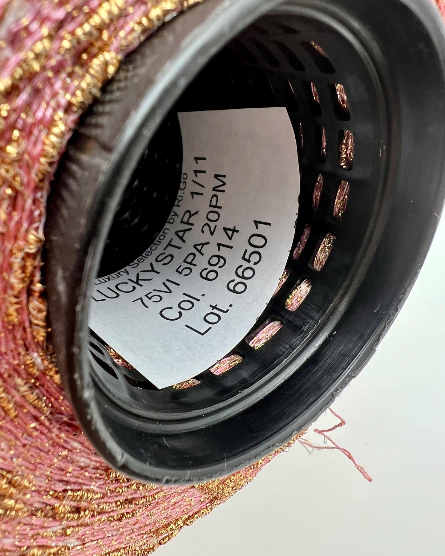 Close-up of a black filter with visible branding and product details on a textured surface.