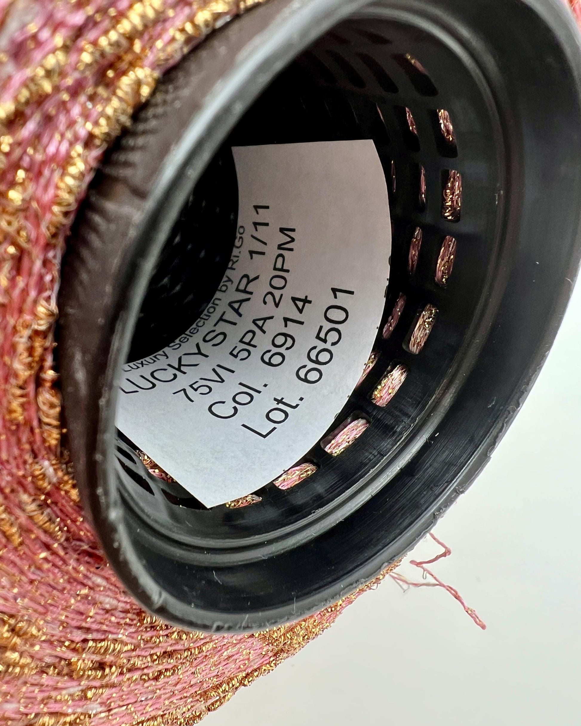 Close-up of a black filter with visible branding and product details on a textured surface.