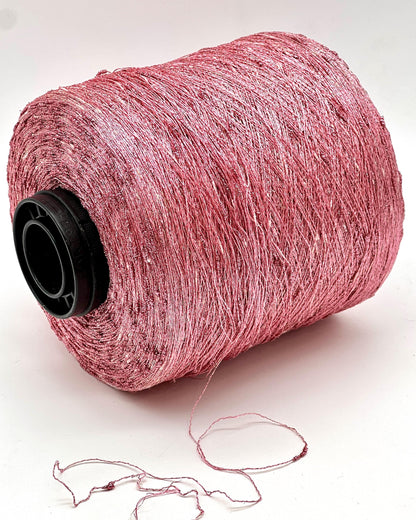 Spool of pink thread on a white background