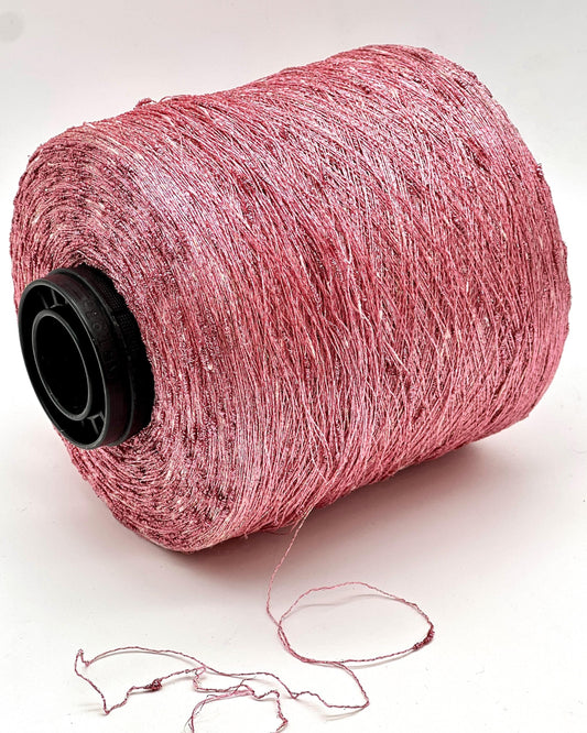 Spool of pink thread on a white background