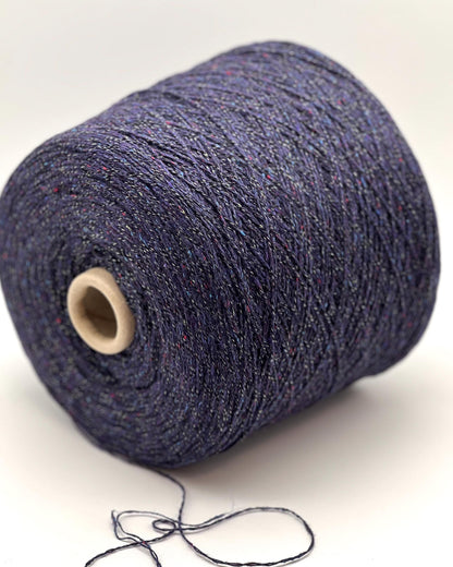 Spool of blue yarn on a white background