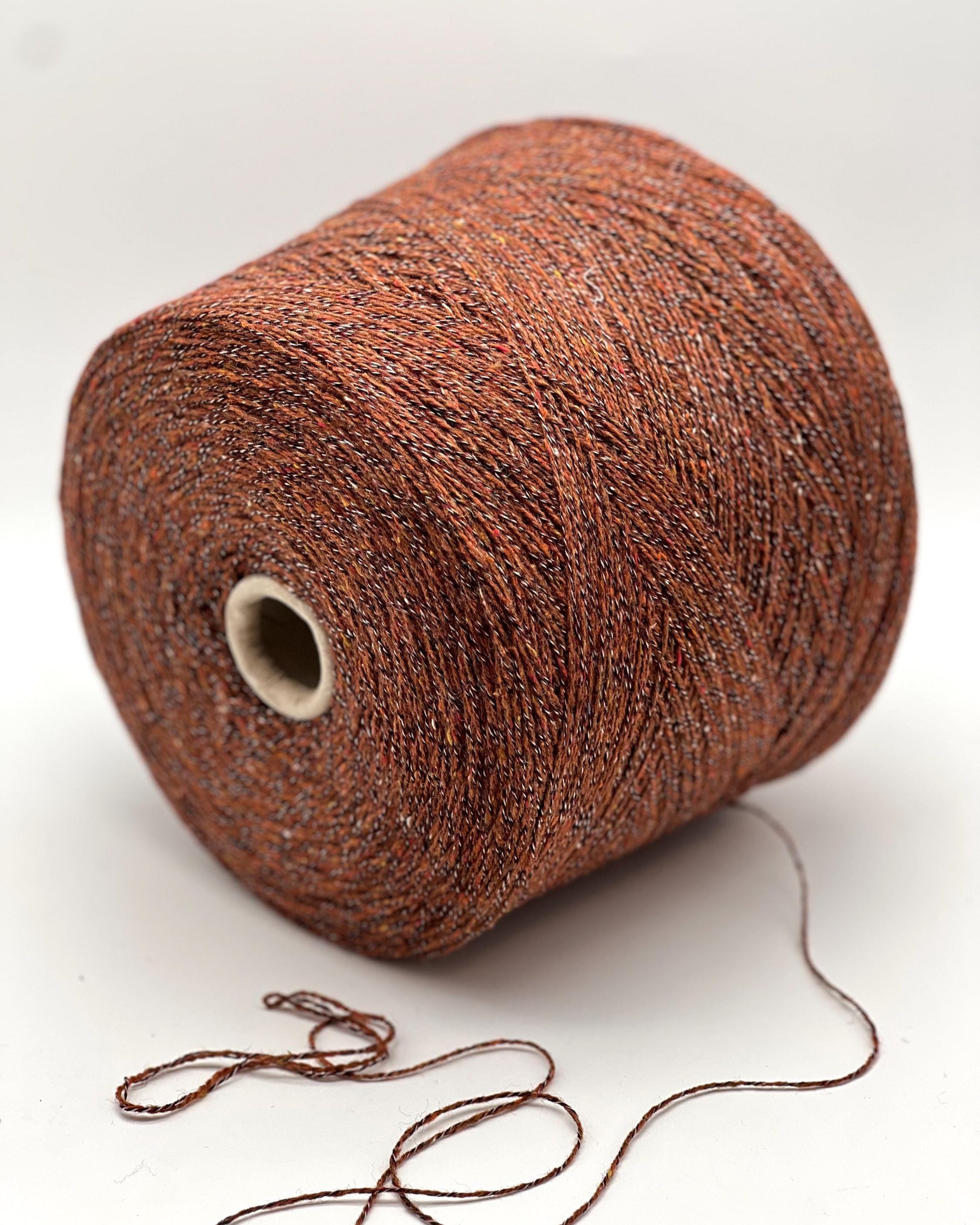 Brown yarn spool on a white background