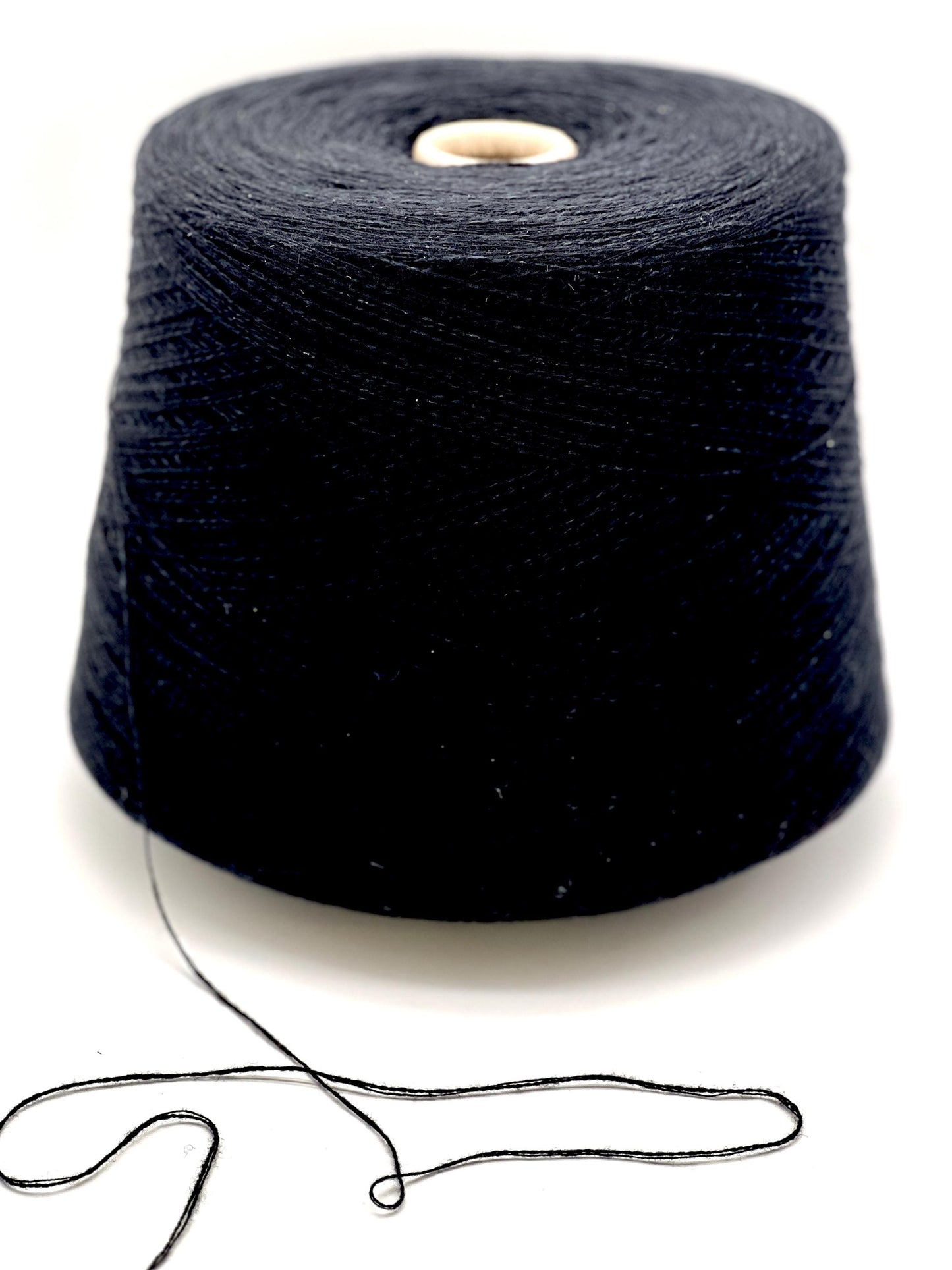 Spool of black yarn on a white background