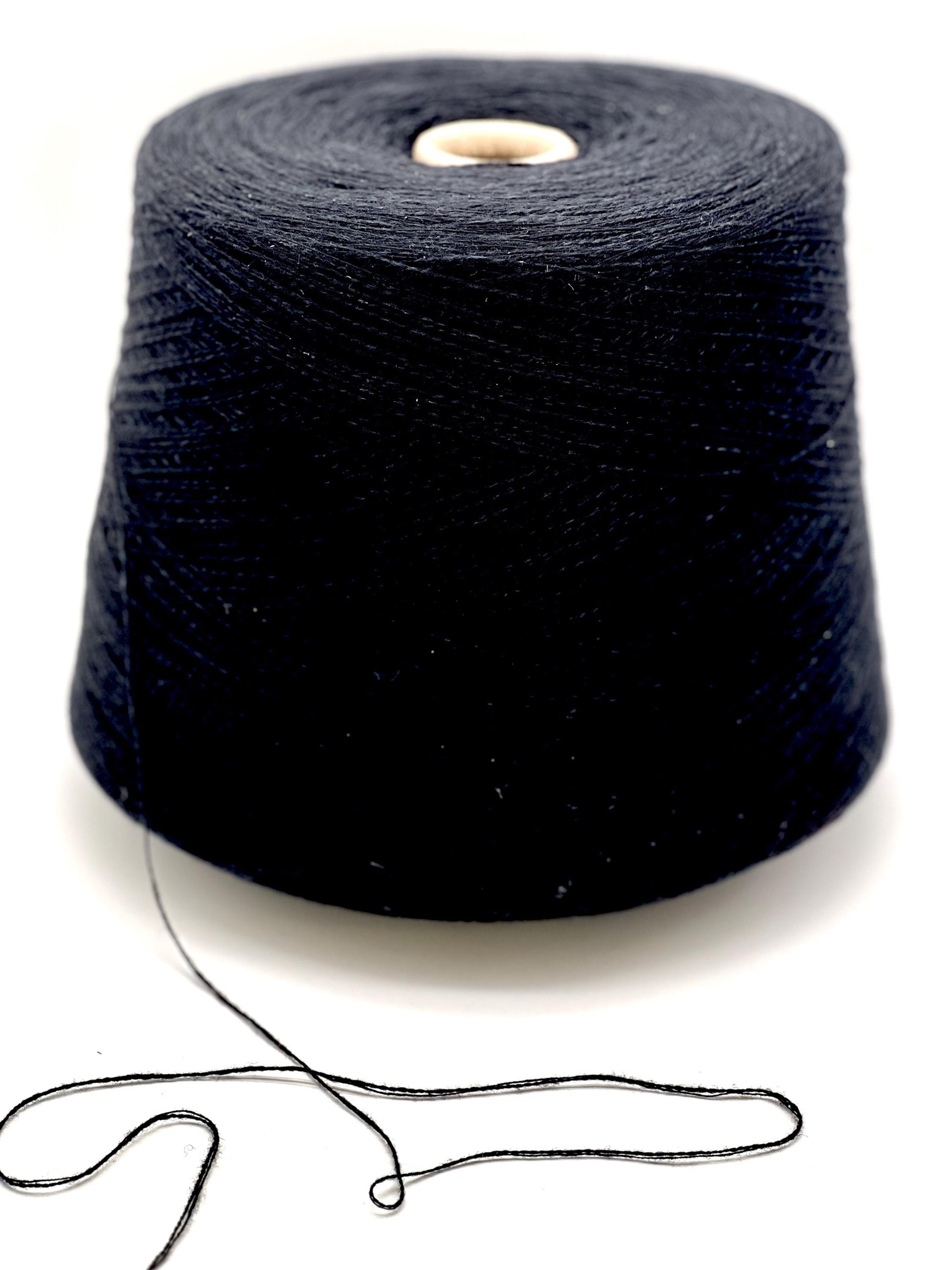 Spool of black yarn on a white background