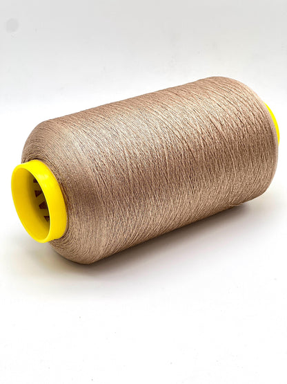 Spool of brown thread with a yellow core on a white background