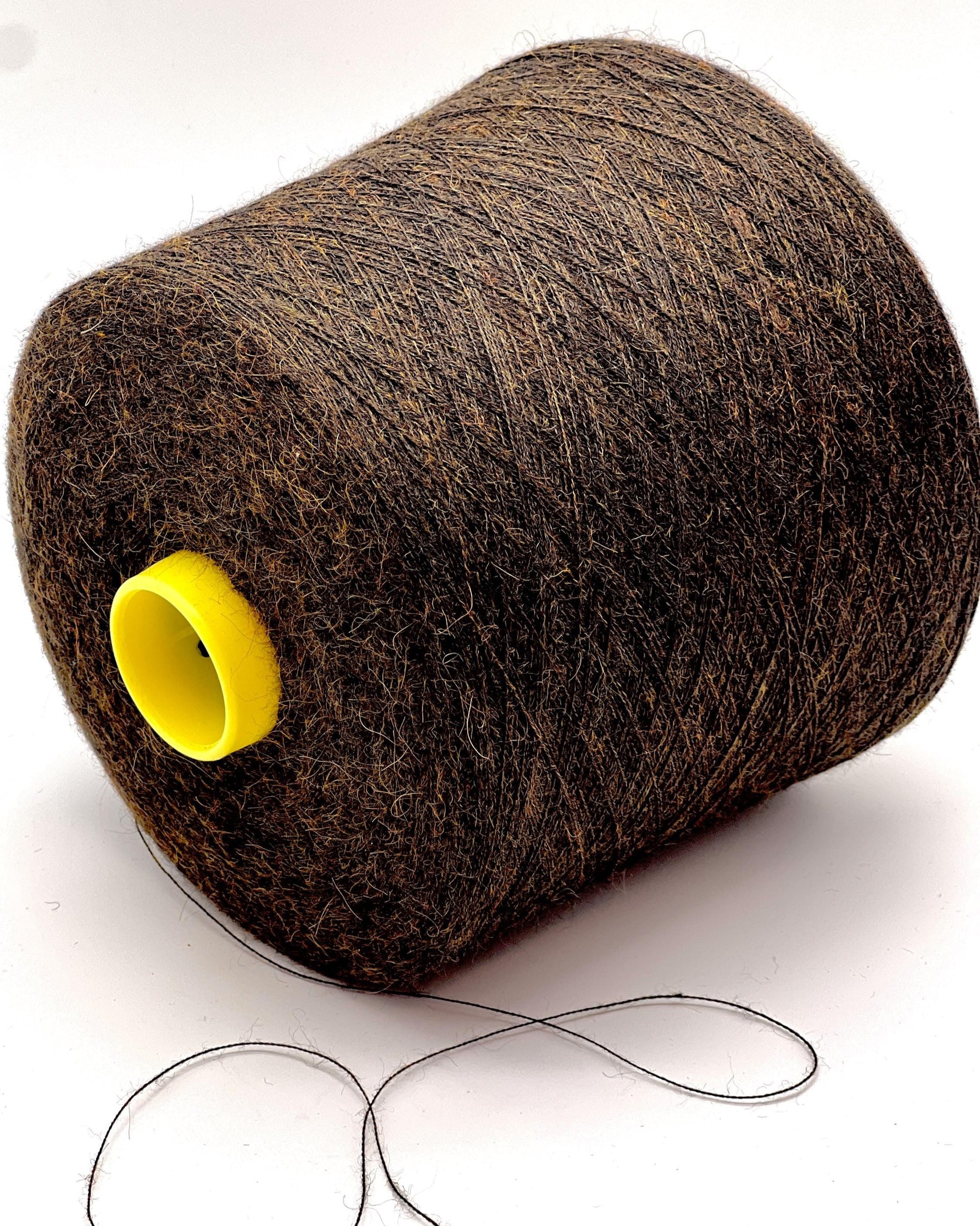 Large spool of brown thread with a yellow core on a white background