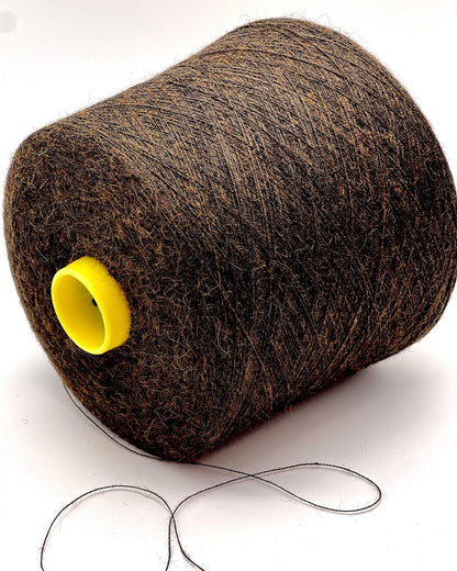 Large spool of brown thread with a yellow core on a white background