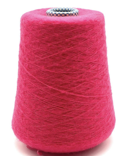 Spool of pink yarn on a white background