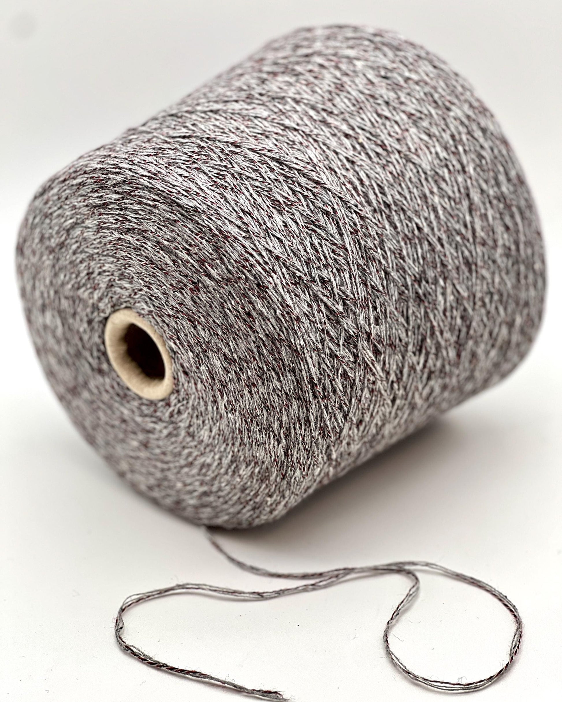 Spool of gray yarn on a white background