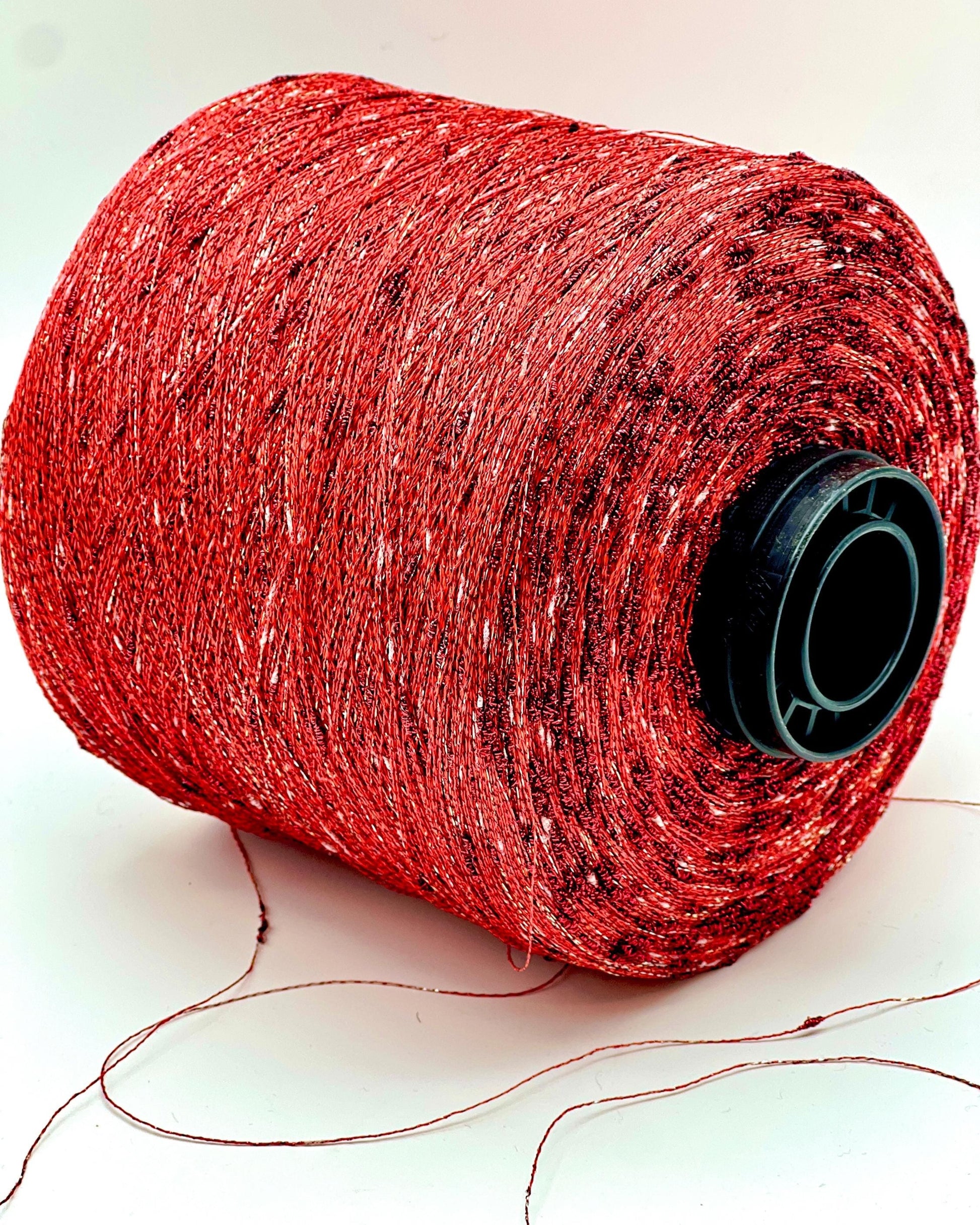 Red spool of thread on a white background