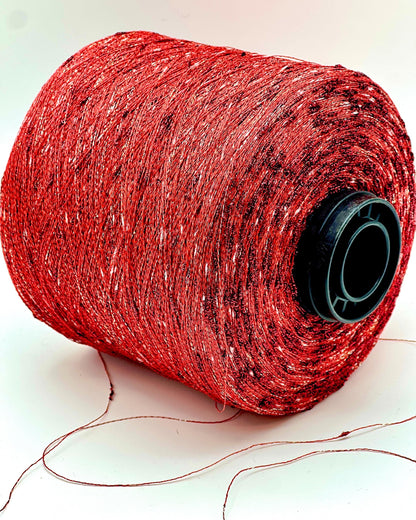 Red spool of thread on a white background