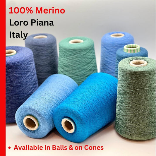 Spools of Loro Piana merino wool yarn in various colors on a light background.