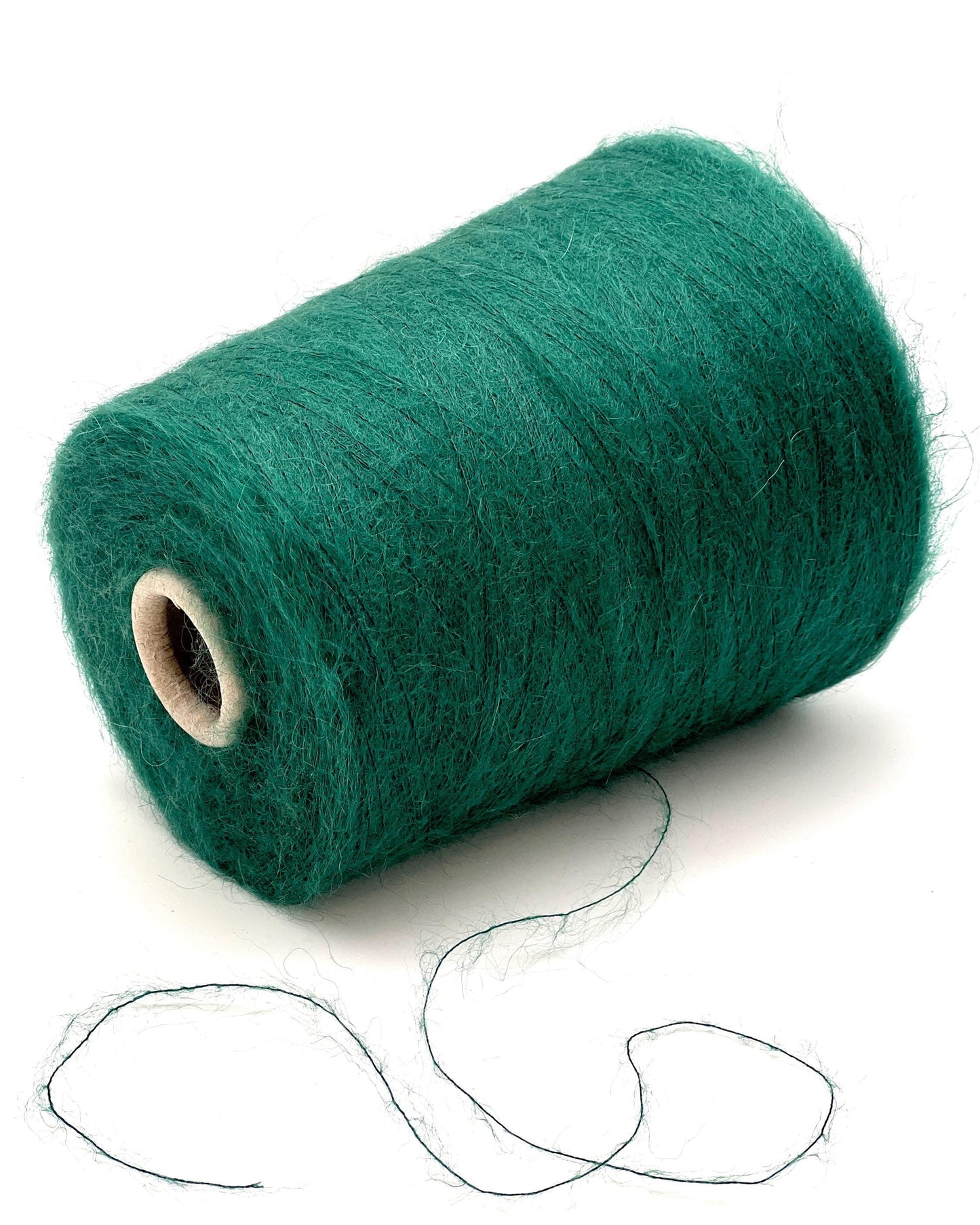 Roll of green yarn on a white background