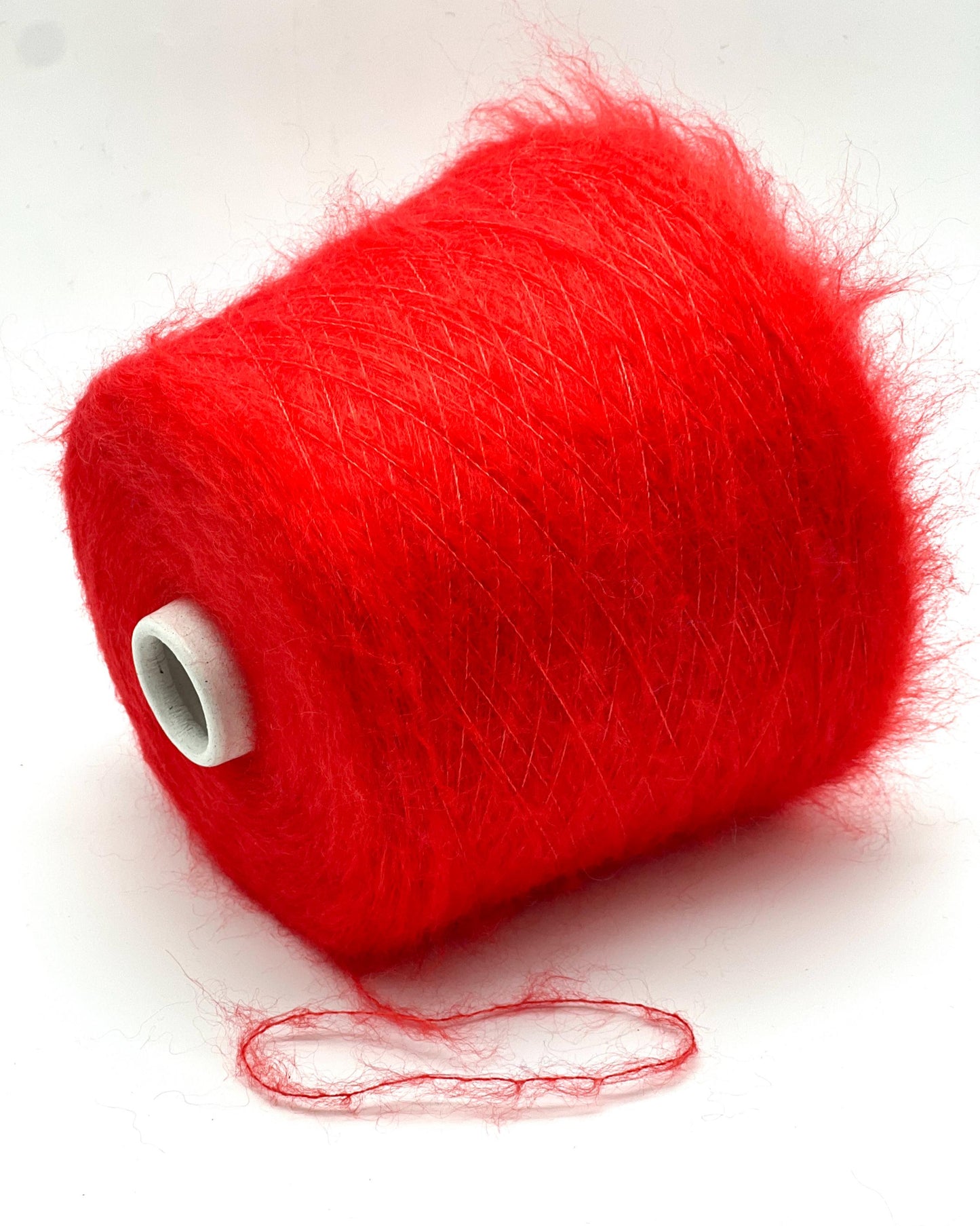 Red yarn spool on a white background