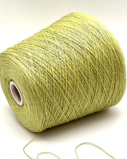 Spool of green yarn on a white background