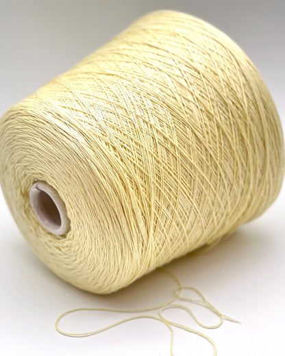 Spool of beige thread on a white background