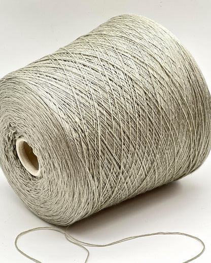 Roll of beige yarn on a white background