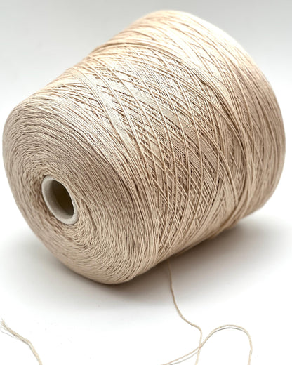 Spool of beige yarn on a white background