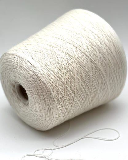 Spool of white yarn on a light gray background