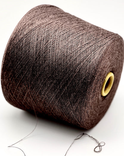 Brown spool of yarn on a white background