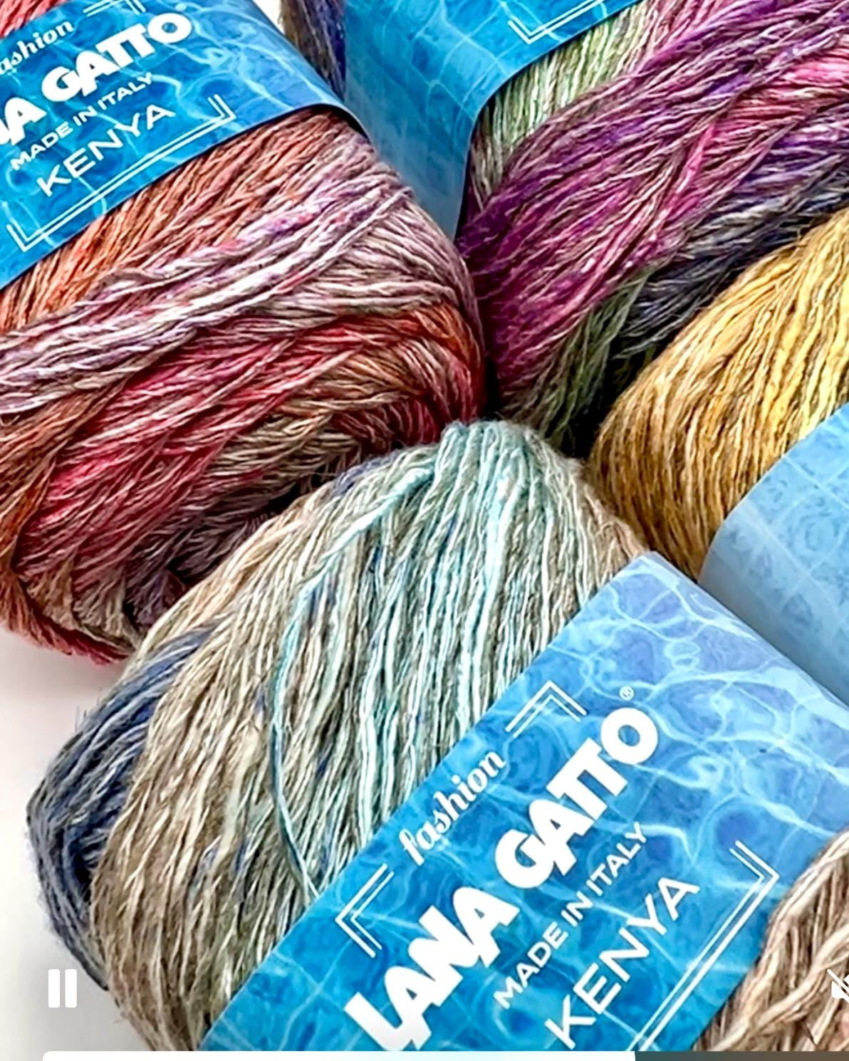 Colorful yarn balls with 'Lana Gatto' labels on a white background