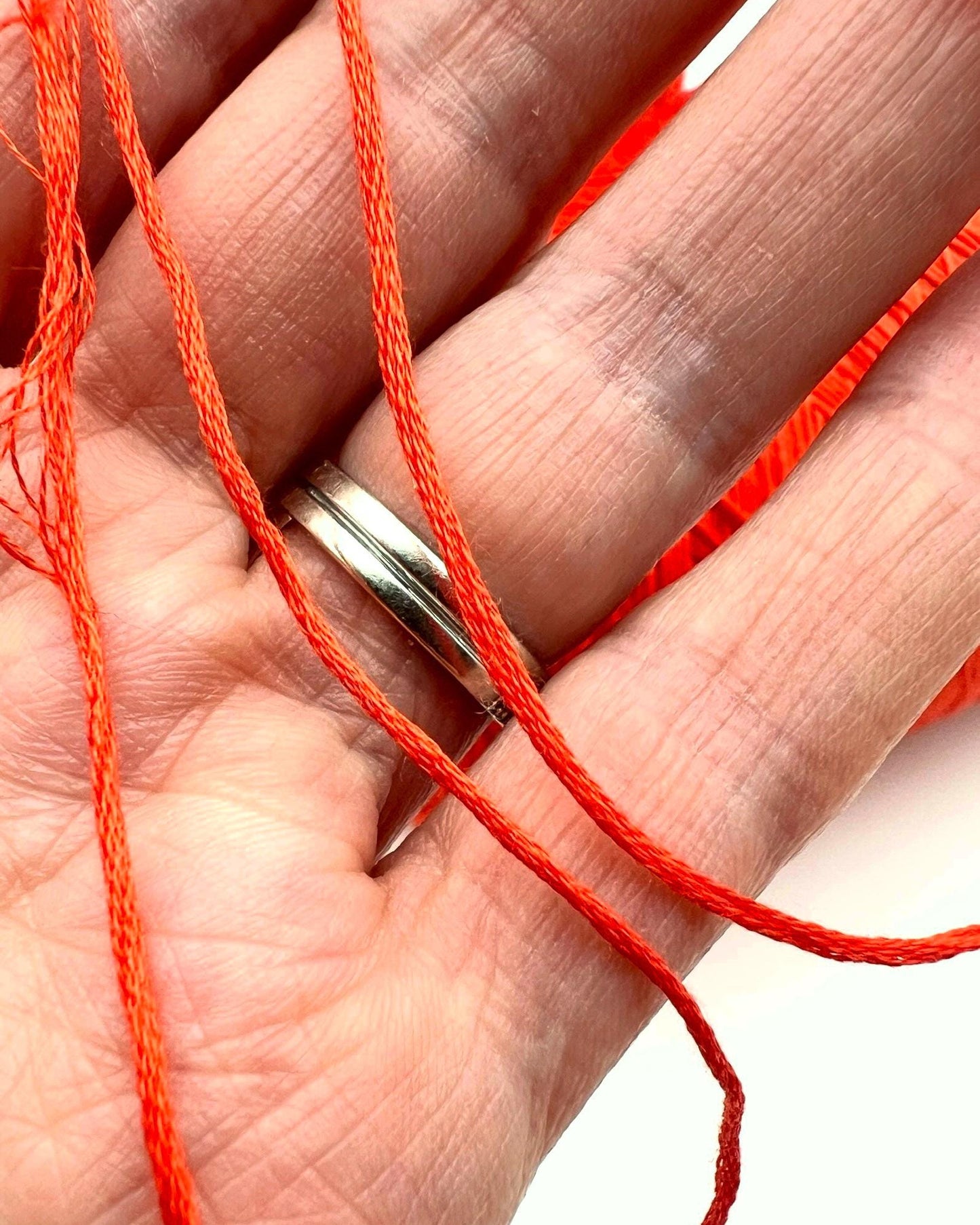 Luxury COTTON SILK lace-weight yarn by Botto Giuseppe, Italy – 55% silk and 45% cotton blend, super soft with an elegant natural sheen. Shown in vibrant coral red on a cone. Ideal for summer tops, lightweight layering, and luxury blending. Premium Italian yarn available at iDOKNiT.com.