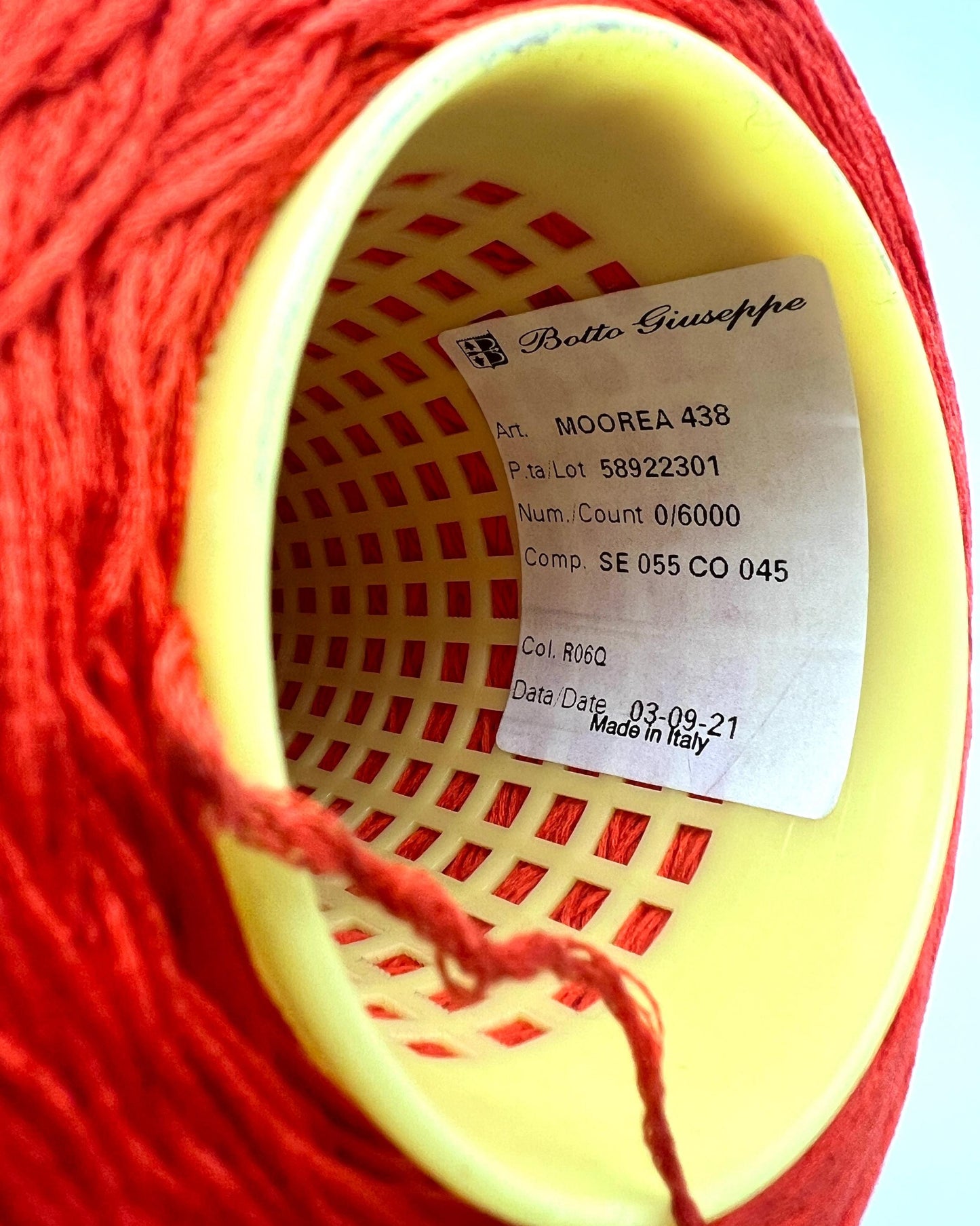 Luxury COTTON SILK lace-weight yarn by Botto Giuseppe, Italy – 55% silk and 45% cotton blend, super soft with an elegant natural sheen. Shown in vibrant coral red on a cone. Ideal for summer tops, lightweight layering, and luxury blending. Premium Italian yarn available at iDOKNiT.com.