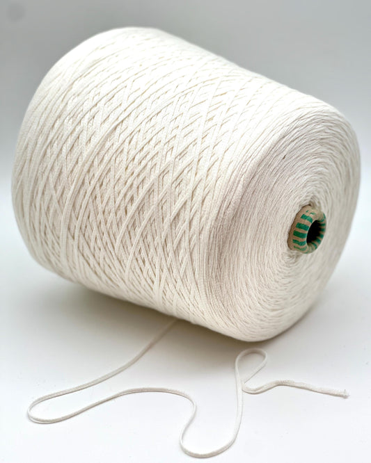 Spool of white yarn on a light gray background